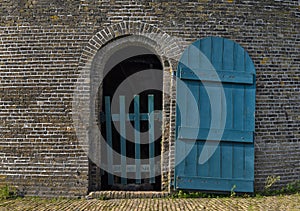 Open blue door on brick structure
