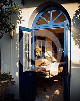 Open blue door heading to the interiors of a modern house.