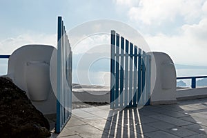 Open blue door overlooking the Mediterranean sea