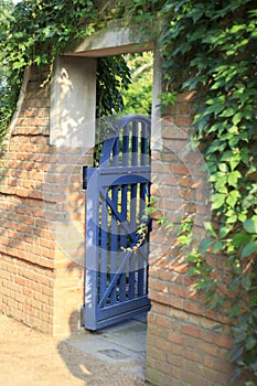 Open Blue Garden Gate Leading into Botanic Garden Area