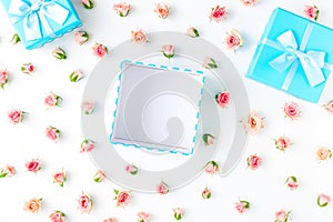 Open blue gift box with pink roses on white background