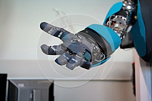 Open blue robot hand closeup