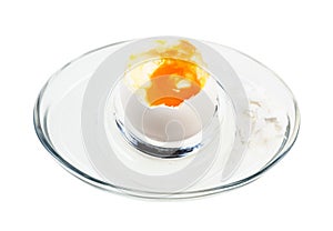 Open boiled white egg in glass egg cup isolated