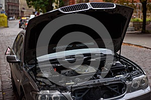 Open bonnet of broken BMW car