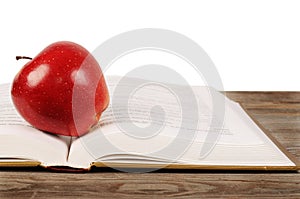 Open book with apple isolated on white background
