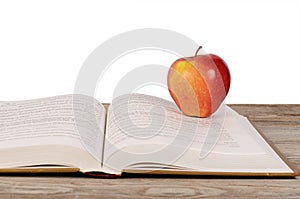 Open book with apple isolated on white background