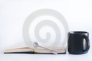 Open book Bible and cup. Iron key. The concept of the path to knowledge