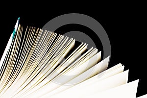 Open book on black background, top view, copy space