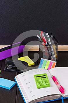 Open book on blackboard