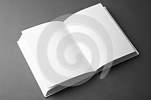 Open book with blank pages on grey background. Mock up for design