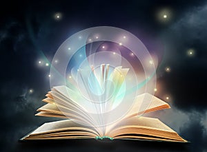 Open book with fairytales and magic lights