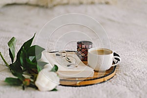 Open book with glasses, cup coffee and bouquet white pink peonies flowers