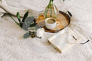 Open book with glasses, cup coffee and bouquet white pink peonies flowers