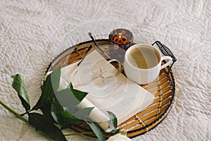 Open book with glasses, cup coffee and bouquet white pink peonies flowers