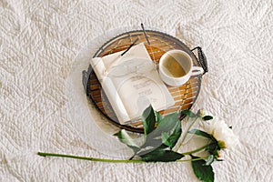 Open book with glasses, cup coffee and bouquet white pink peonies flowers