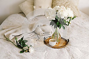 Open book with glasses, cup coffee and bouquet white pink peonies flowers