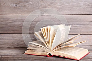 Open book on a grey wooden table