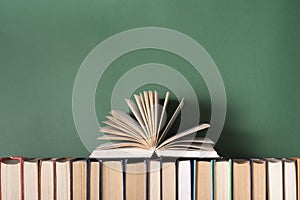 Open book, hardback books on wooden table. Education background. Back to school. Copy space for text.