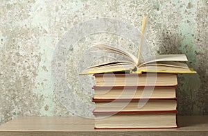 Open book, hardback books on wooden table. Education background. Back to school. Copy space for text.