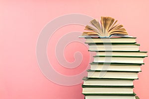 Open book, hardback books on wooden table, on a pink background. Back to school. Copy space for text. Education background