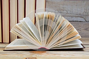 Open book, hardback books on wooden table. wooden background. Back to school. Education. Copy space for text