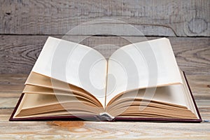 Open book, hardback books on wooden table. wooden background. Back to school. Education. Copy space for text