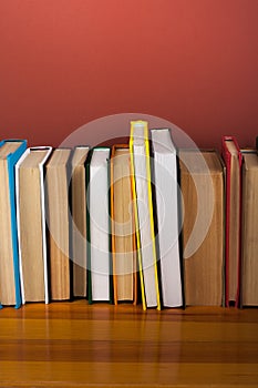 Open book, hardback colorful books on wooden table. Back to school. Copy space for text. Education business concept.