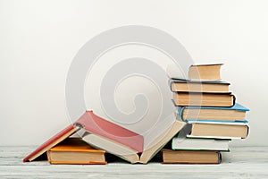 Open book, hardback colorful books on wooden table. Back to school. Copy space for text. Education business concept