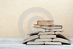 Open book, hardback colorful books on wooden table. Back to school. Copy space for text. Education business concept