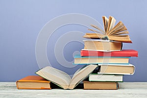 Open book, hardback colorful books on wooden table. Back to school. Copy space for text. Education business concept