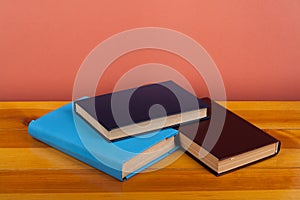 Open book, hardback colorful books on wooden table. Back to school. Copy space for text. Education business concept