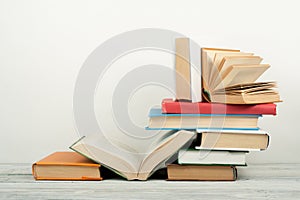 Open book, hardback colorful books on wooden table. Back to school. Copy space for text. Education business concept