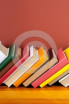 Open book, hardback colorful books on wooden table. Back to school. Copy space for text. Education business concept