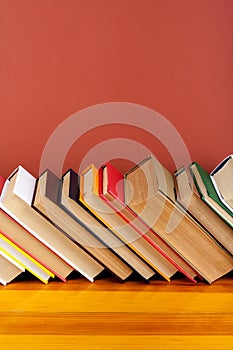 Open book, hardback colorful books on wooden table. Back to school. Copy space for text. Education business concept.