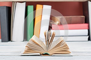 Open book, hardback colorful books on wooden table. Back to school. Copy space for text. Education business concept.