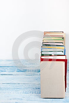 Open book, hardback colorful books on wooden table background. Back to school. Copy space for text. Education business