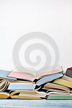 Open book, hardback colorful books on wooden table , white Background. Back to school. Copy space for text. Education business