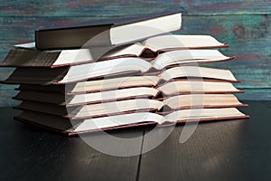 Open book hardback on Stack books