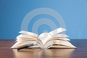 open book with magnifying glass on wooden desk in information library of school or university, concept for education,reading ,