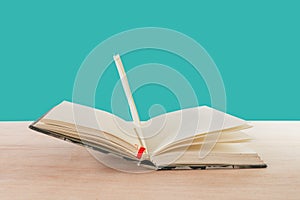 Open book old on wooden floor isolated on blue background with copy space add text