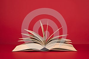 Open book with pages on a red background