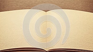 Open book, pages spread wide, light beige tone