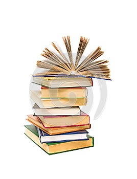 Open book on a pile of books on a white background