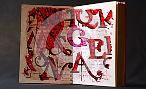 An open book of red letters