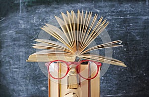 Open book and spectacles on a stack of books, reading, education,learning concept,  free copy space