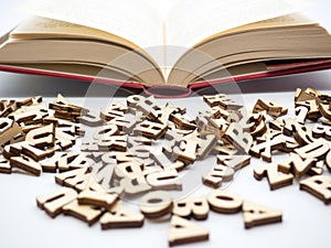 Open book and spread letters education encyclopedia concept photo