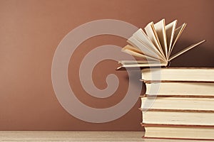 Open book and stack of books on wooden table. Education background. Back to school.Copy space for text.