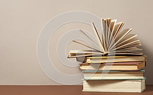 Open book and stack of books on wooden table. Education background. Back to school.Copy space for text.