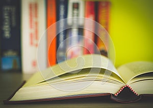 Open book, stack of colorful hardback books isolated on white background. Back to school. Copy space for text. Toned image