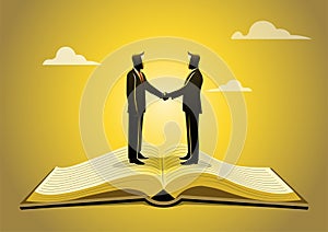 An open book with two businessmen shaking hands above it